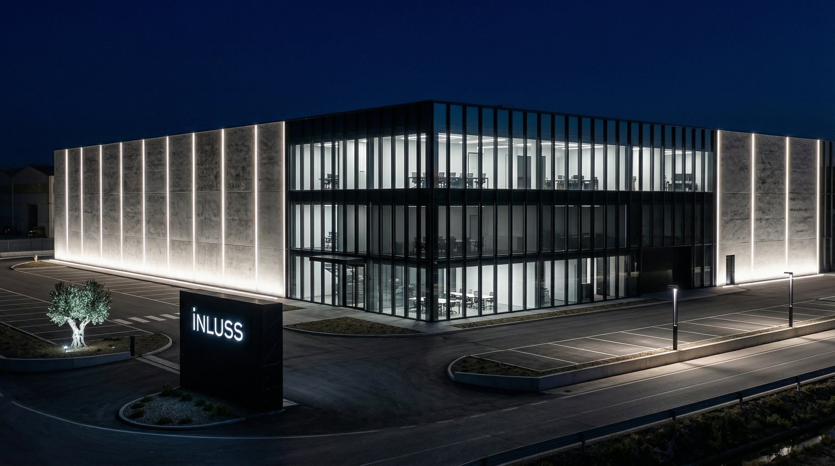 INLuss building with illuminated facade at night.